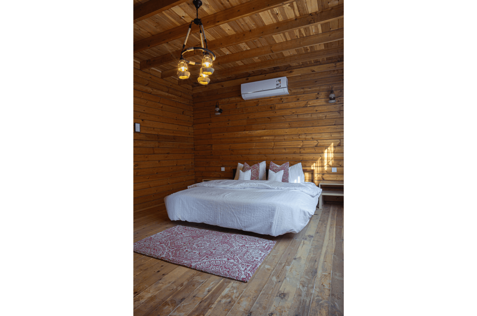 A bedroom with wooden walls and floors