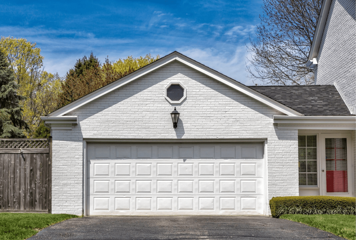 A white garage with two doors and a sky background