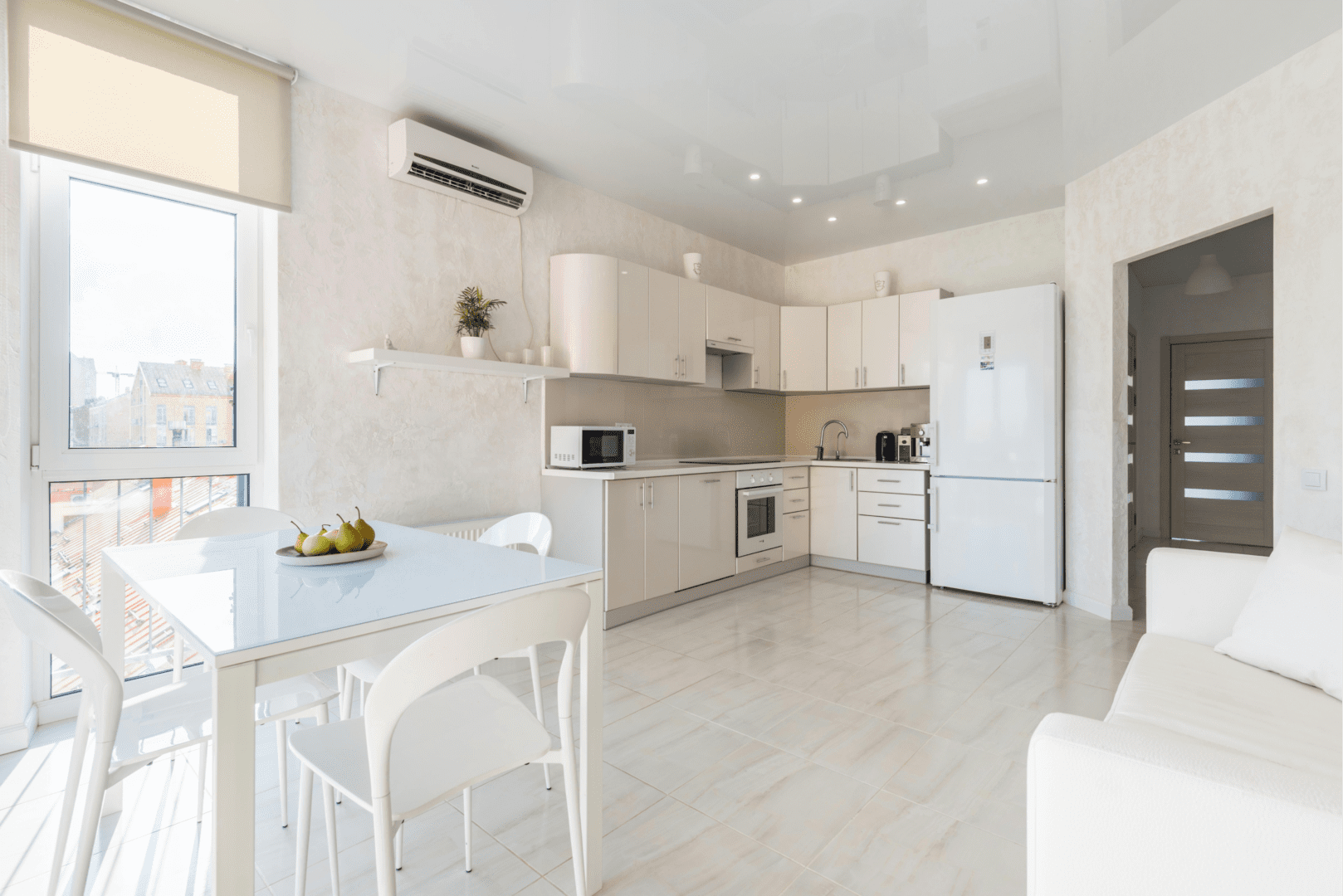 A kitchen with white cabinets and a table